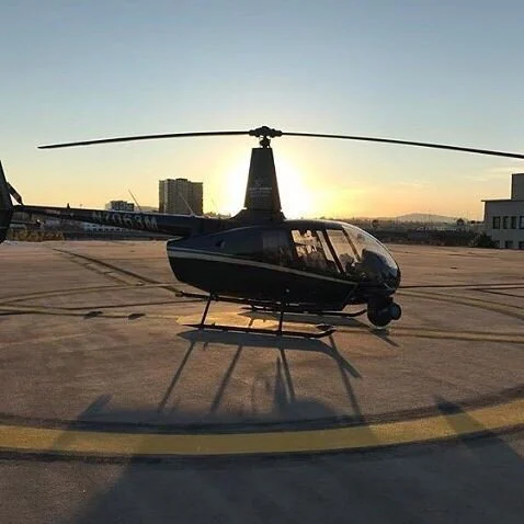 Robinson R-66 turbine helicopter flying downtown