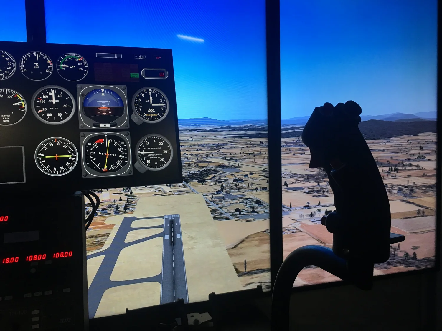 Student pilot at the controls of the TH-100 turbine simulator